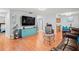 Living room featuring wood floors, large television, and adjacent kitchen view at 802 Antler Ct, Brandon, FL 33511