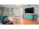 Living room featuring wood floors, glass table, blue accents and sliding doors at 802 Antler Ct, Brandon, FL 33511
