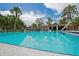 Refreshing community pool featuring clear blue water, comfortable lounge chairs and mature trees in a relaxing setting at 802 Antler Ct, Brandon, FL 33511