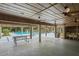 A poolside view featuring a large seating area, picnic tables, and outdoor cooking space, perfect for summer get-togethers at 802 Antler Ct, Brandon, FL 33511
