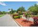 A beautifully landscaped street view of the community featuring mature trees, colorful flowers, and well-maintained grounds at 802 Antler Ct, Brandon, FL 33511