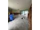 Spacious living room under renovation with gray tile flooring and sliding glass doors at 802 White Heron Blvd, Ruskin, FL 33570