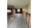 Renovated living room featuring gray tile floors, large windows, and an open floorplan at 802 White Heron Blvd, Ruskin, FL 33570