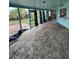 Enclosed porch has tiled flooring and large windows at 802 White Heron Blvd, Ruskin, FL 33570