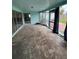 Spacious sunroom with tiled flooring and sliding glass doors needs renovation at 802 White Heron Blvd, Ruskin, FL 33570