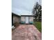 Exterior shed featuring a paved patio area and garden planters on either side at 802 White Heron Blvd, Ruskin, FL 33570
