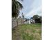 Waterfront view showing a wooden fence, grassy area and a canal with boat docks at 802 White Heron Blvd, Ruskin, FL 33570