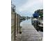 Beautiful waterfront view from a wooden dock showcasing a calm canal and boats at 802 White Heron Blvd, Ruskin, FL 33570