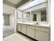 Bathroom featuring a vanity with a large mirror and neutral color scheme at 8630 134Th St, Seminole, FL 33776