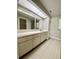 Bathroom with vanity, a large mirror, and ample storage space at 8630 134Th St, Seminole, FL 33776