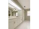 Bright bathroom with a large mirror, dual sinks, and modern fixtures and good lighting at 8630 134Th St, Seminole, FL 33776