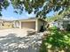 Side view of a home with a two car garage, showing air conditioning units and green grass at 8630 134Th St, Seminole, FL 33776