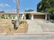 Charming single-story home featuring a well-kept lawn, a two-car garage, and a mailbox in the front yard at 8630 134Th St, Seminole, FL 33776