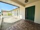 Home entryway featuring a green front door, brick-laid porch, and front patio at 8630 134Th St, Seminole, FL 33776