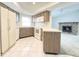 Bright kitchen featuring white appliances, wood cabinetry, and access to living room at 8630 134Th St, Seminole, FL 33776