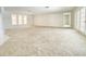 Bright living room with neutral carpet, white trim, and multiple windows at 8630 134Th St, Seminole, FL 33776