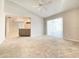 Bright living room with carpet and sliding glass door, connected to kitchen at 8630 134Th St, Seminole, FL 33776