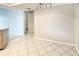 Open living room with tile flooring leading to hallway and neutral wall color at 8630 134Th St, Seminole, FL 33776