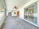 Long tiled patio with screens and fans overlooking a pool, ideal for outdoor relaxation and entertaining at home at 8630 134Th St, Seminole, FL 33776