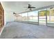 Enclosed tiled patio with fans overlooking a sparkling pool, perfect for relaxation and entertaining in your new home at 8630 134Th St, Seminole, FL 33776