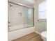 Clean bathroom featuring a tub with sliding glass door, tile surround, and modern fixtures at 8630 134Th St, Seminole, FL 33776