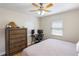 Bedroom with light-colored walls, wood-look flooring, a ceiling fan, and plenty of natural light at 918 27Th N St, St Petersburg, FL 33713