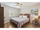 Cozy bedroom with wood-look floors, a ceiling fan, and natural light streaming through the window at 918 27Th N St, St Petersburg, FL 33713