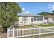 Inviting single-story home with a white picket fence and lush green lawn at 918 27Th N St, St Petersburg, FL 33713