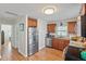 Well-lit kitchen featuring hardwood floors, stainless steel appliances, and wood cabinetry at 918 27Th N St, St Petersburg, FL 33713