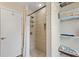 Modern shower with tiled walls and floors, along with built-in shelving for convenient storage at 918 27Th N St, St Petersburg, FL 33713