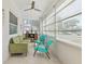 Bright sun room featuring tile flooring, a ceiling fan, and comfortable seating at 918 27Th N St, St Petersburg, FL 33713
