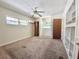Spacious bedroom featuring neutral carpet and paint with ceiling fan and built in shelves at 9797 52Nd N Ter, St Petersburg, FL 33708