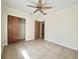 Bedroom with tiled floor, ceiling fan and closet at 9797 52Nd N Ter, St Petersburg, FL 33708