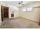 Bedroom showing carpet, ceiling fan, and bathroom doorway at 9797 52Nd N Ter, St Petersburg, FL 33708