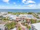 Aerial shot of the community building complex near waterfront with landscaping, trees, and blue skies in the background at 1005 Main St, Safety Harbor, FL 34695