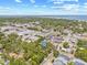Aerial view of a neighborhood, highlighting the lush surroundings and a glimpse of the bay in the distance at 1005 Main St, Safety Harbor, FL 34695