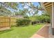 Backyard featuring a new fence, bushes, well maintained lawn, and brick pathway at 1005 Main St, Safety Harbor, FL 34695