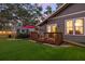 Well-maintained backyard with artificial turf, a wooden deck, and mature trees at 1005 Main St, Safety Harbor, FL 34695