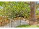 Picturesque backyard garden with white gravel, lush greenery, and decorative fencing at 1005 Main St, Safety Harbor, FL 34695