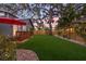 Expansive backyard with lush lawn, wooden fence, and a charming outdoor dining area at 1005 Main St, Safety Harbor, FL 34695