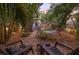 Inviting backyard patio with brick path and lush, tropical landscaping perfect for outdoor relaxation at 1005 Main St, Safety Harbor, FL 34695