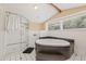 Elegant bathroom featuring a soaking tub, glass-enclosed shower, and classic black and white tile flooring at 1005 Main St, Safety Harbor, FL 34695