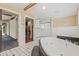 Bathroom featuring a soaking tub and separate shower with an open view to other rooms in the home at 1005 Main St, Safety Harbor, FL 34695