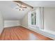 Bedroom features a ceiling fan, wood flooring, and large windows with lots of natural light at 1005 Main St, Safety Harbor, FL 34695