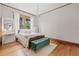 Charming bedroom features wood floors, chandelier, natural light, and elegant furnishings at 1005 Main St, Safety Harbor, FL 34695