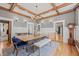 Elegant dining room with a chandelier, coffered ceiling, hardwood floors, and charming architectural details at 1005 Main St, Safety Harbor, FL 34695