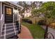 A cozy entrance with a black door, steps, and a small, well-kept lawn and garden at 1005 Main St, Safety Harbor, FL 34695