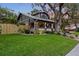 Charming two-story home with a spacious front yard and inviting front porch at 1005 Main St, Safety Harbor, FL 34695