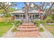 Charming two-story home featuring a brick entry, a spacious lawn, and mature trees at 1005 Main St, Safety Harbor, FL 34695