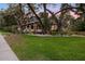 Beautiful home with mature trees, lush lawn, and a welcoming front porch at 1005 Main St, Safety Harbor, FL 34695